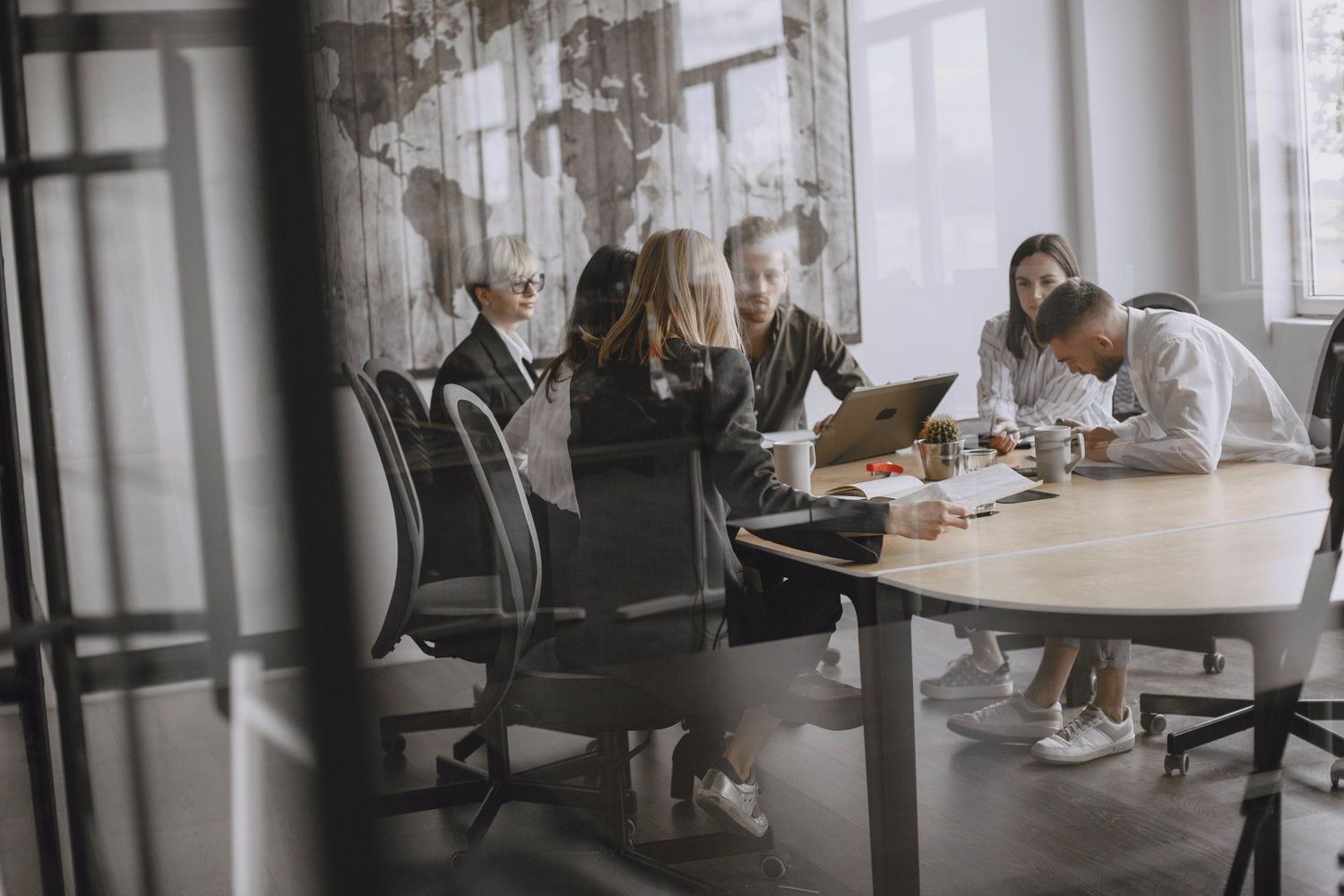 A leadership team working through a plan around a meeting table